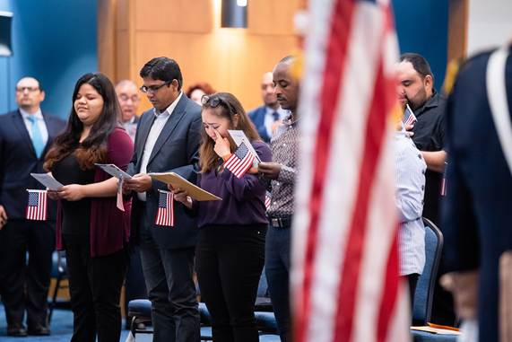 Immigrants taking the Oath of Allegiance at a naturalization ceremony